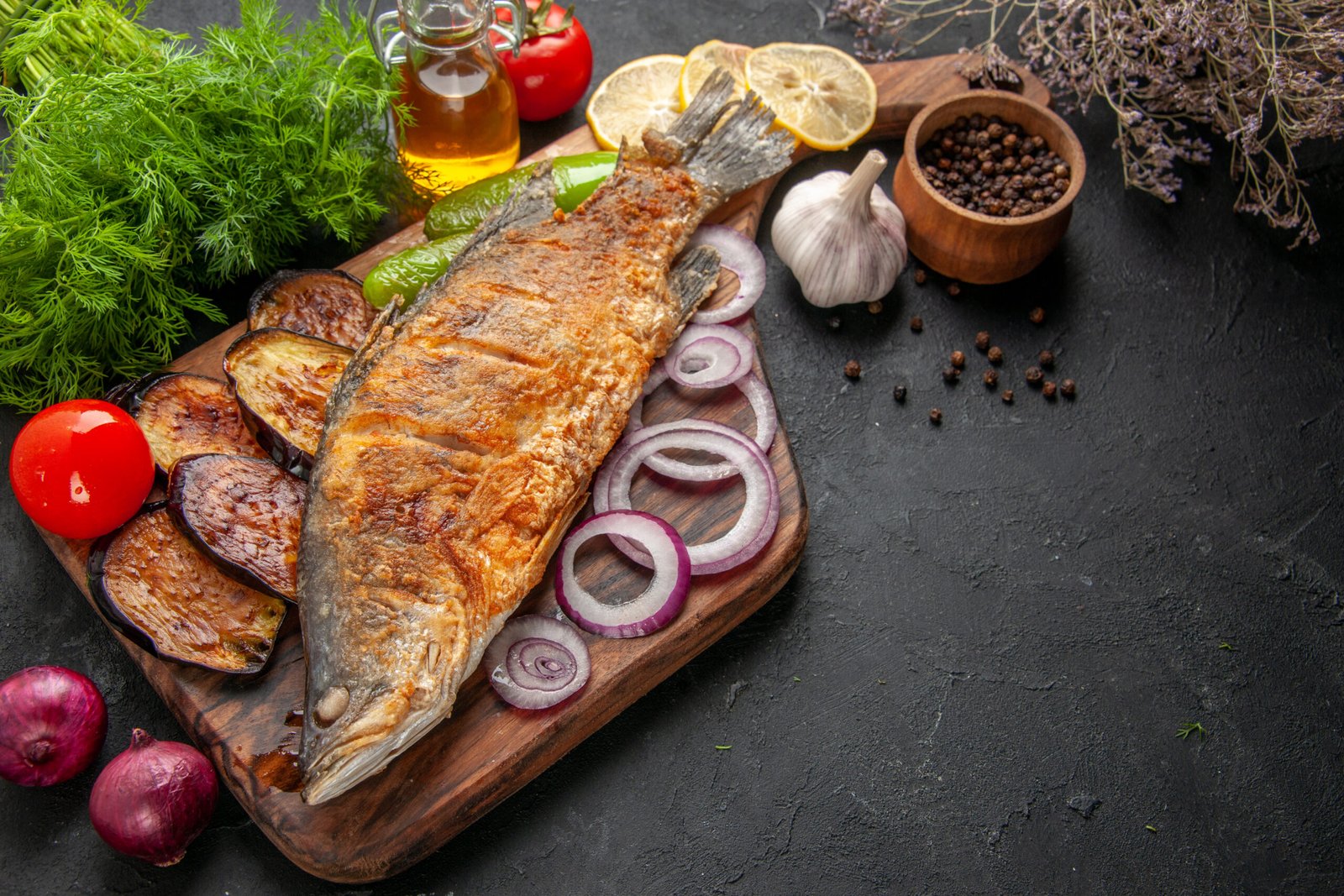 bottom-view-fish-fry-fried-eggplants-onion-wood-serving-board-black-pepper-bowl-oil-bottle-dill-dark-background
